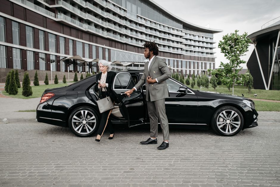 Professional driver opening car door for client, driver for hire Nairobi