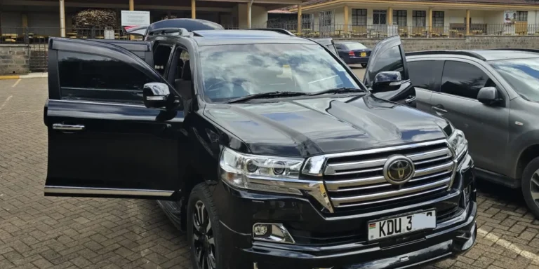Black Toyota Land Cruiser V8 hire vehicle with its front doors open in Nairobi